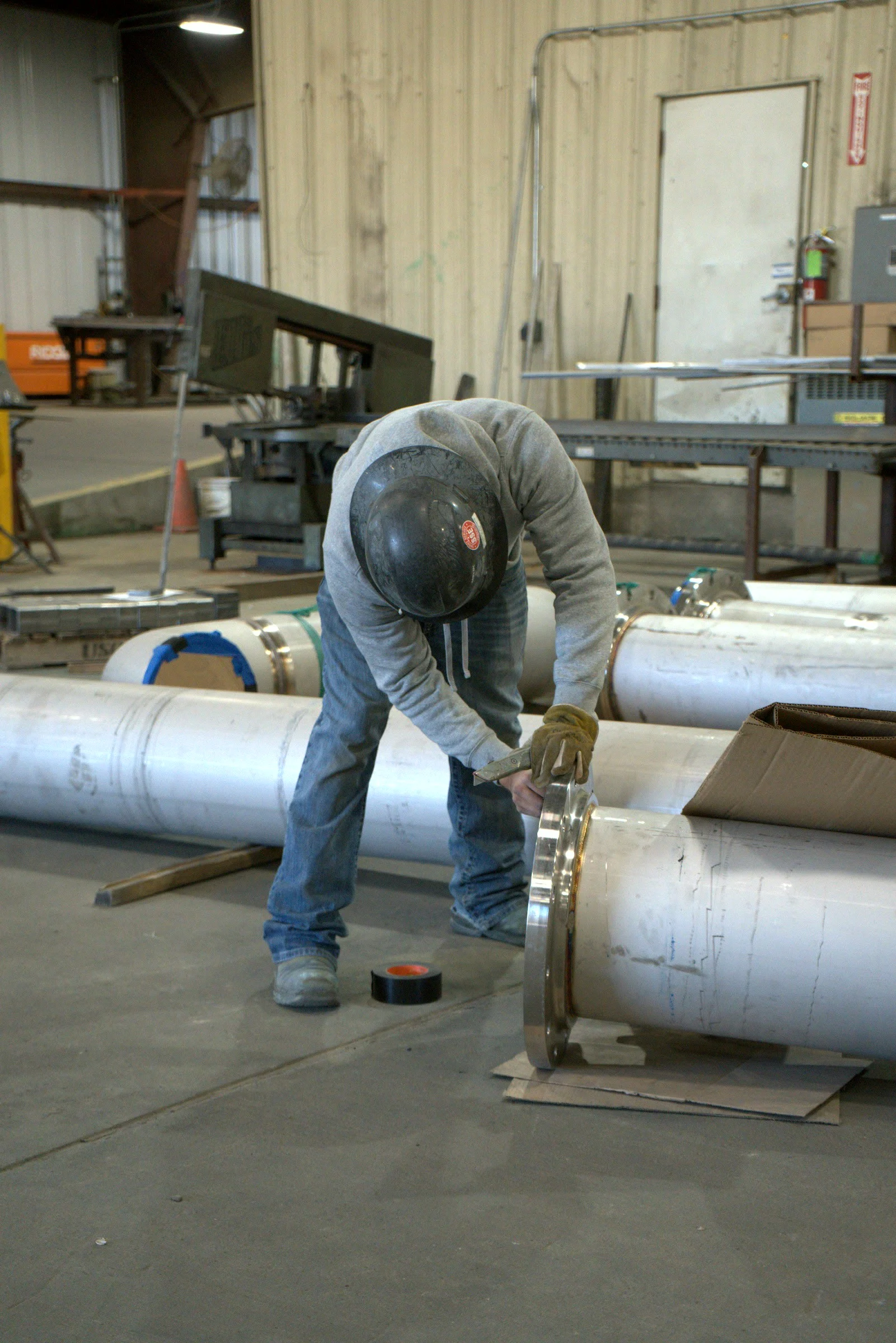 Fitter checking a joint at the Hawk Fabrication shop