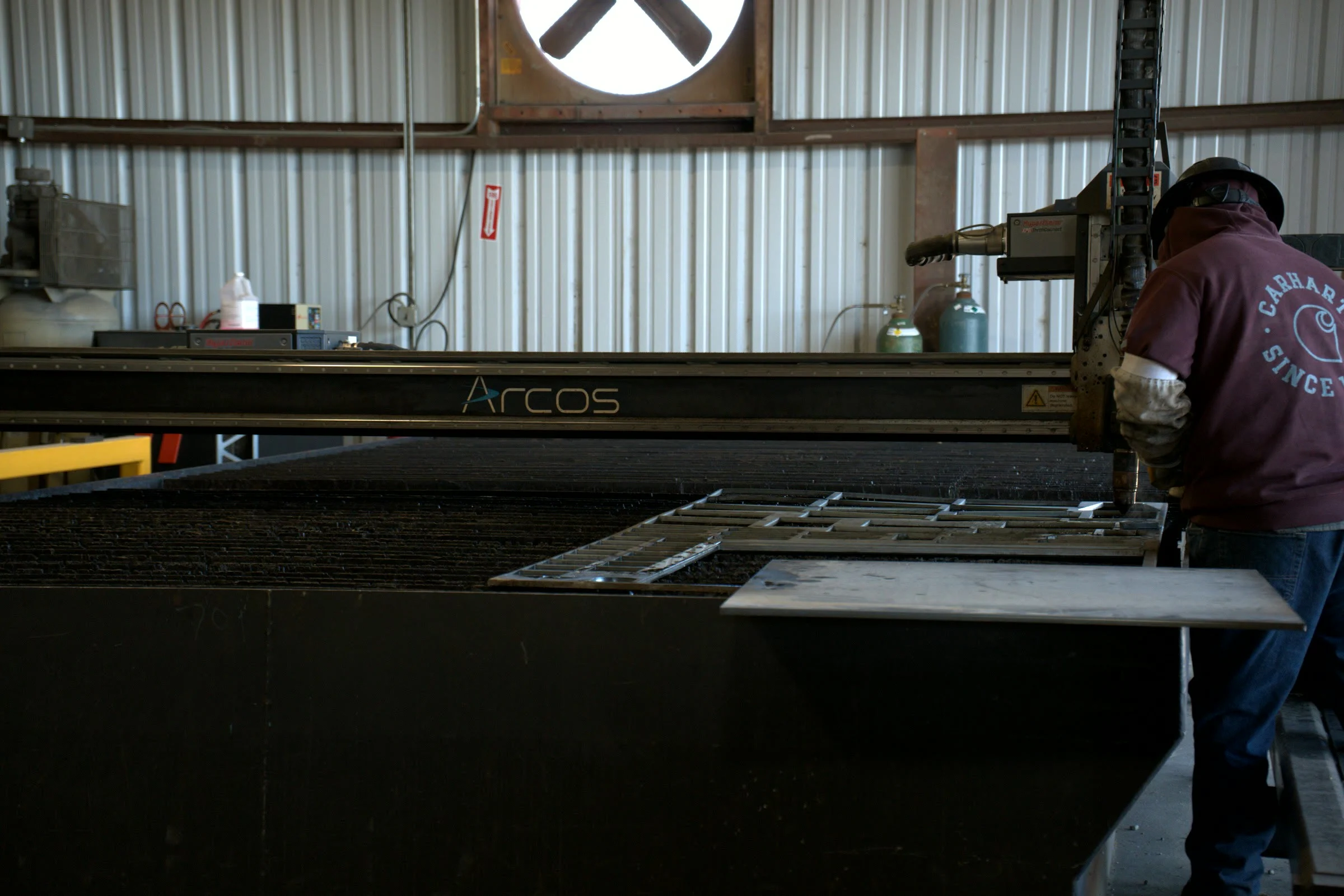Operator running the CNC plasma table at the Hawk Fabrication shop