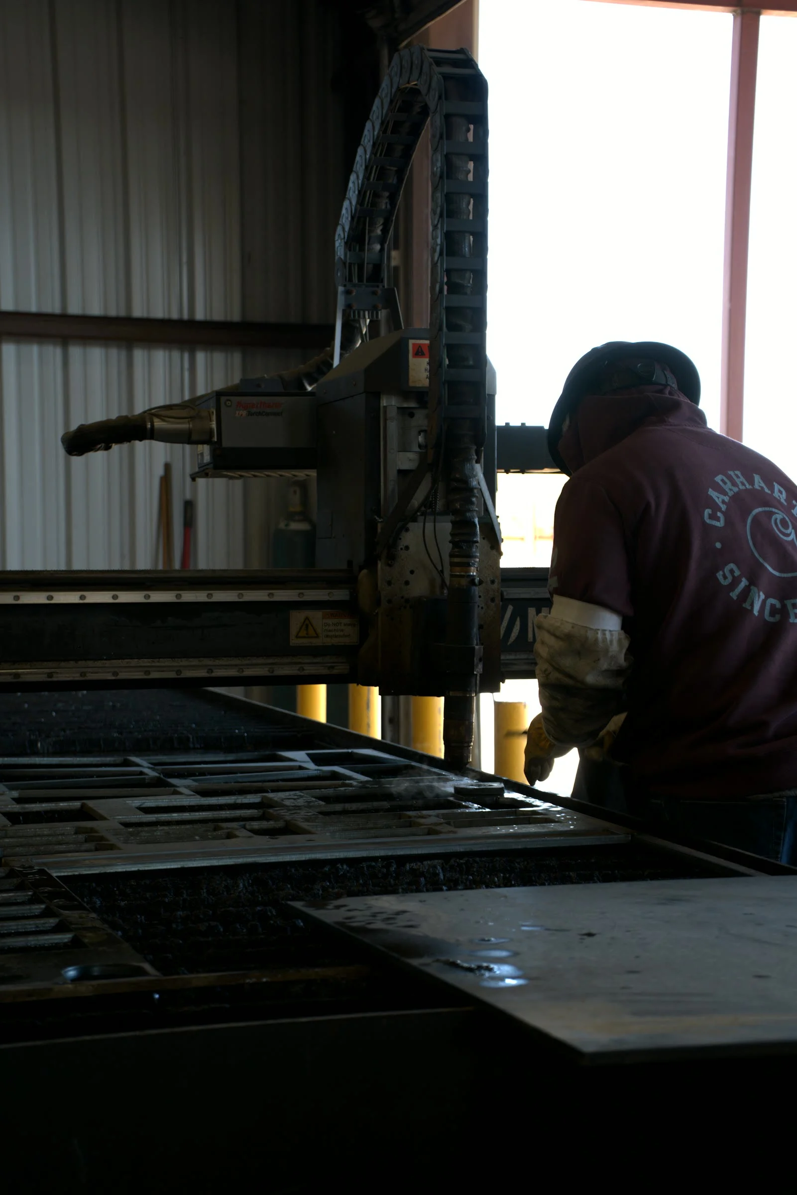 Operator at the drill line at the Hawk Fabrication shop