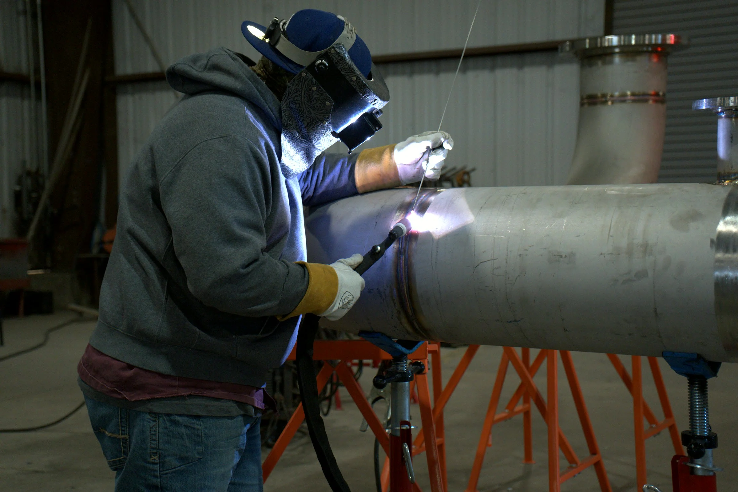 Hawk Fabrication shop floor, a welder on pipe
